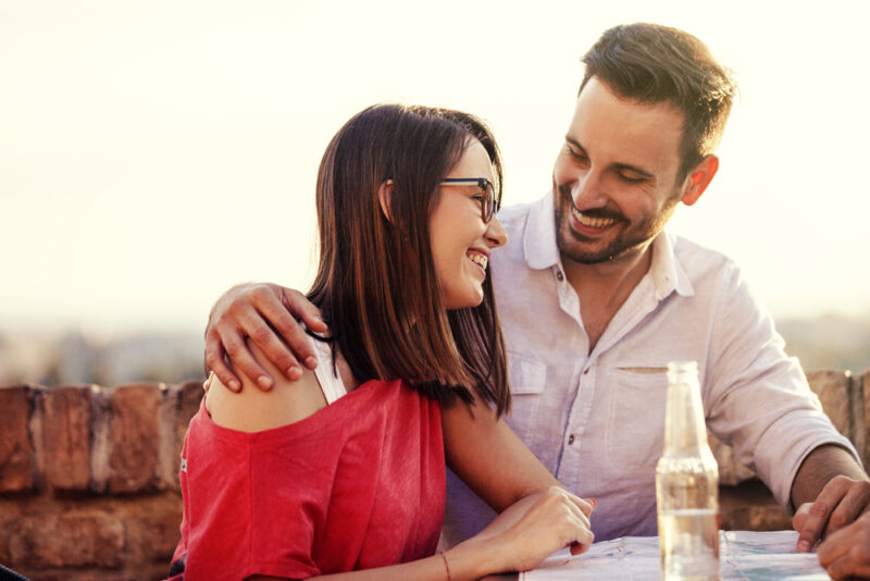 Young and attractive couple is enjoying sunset.