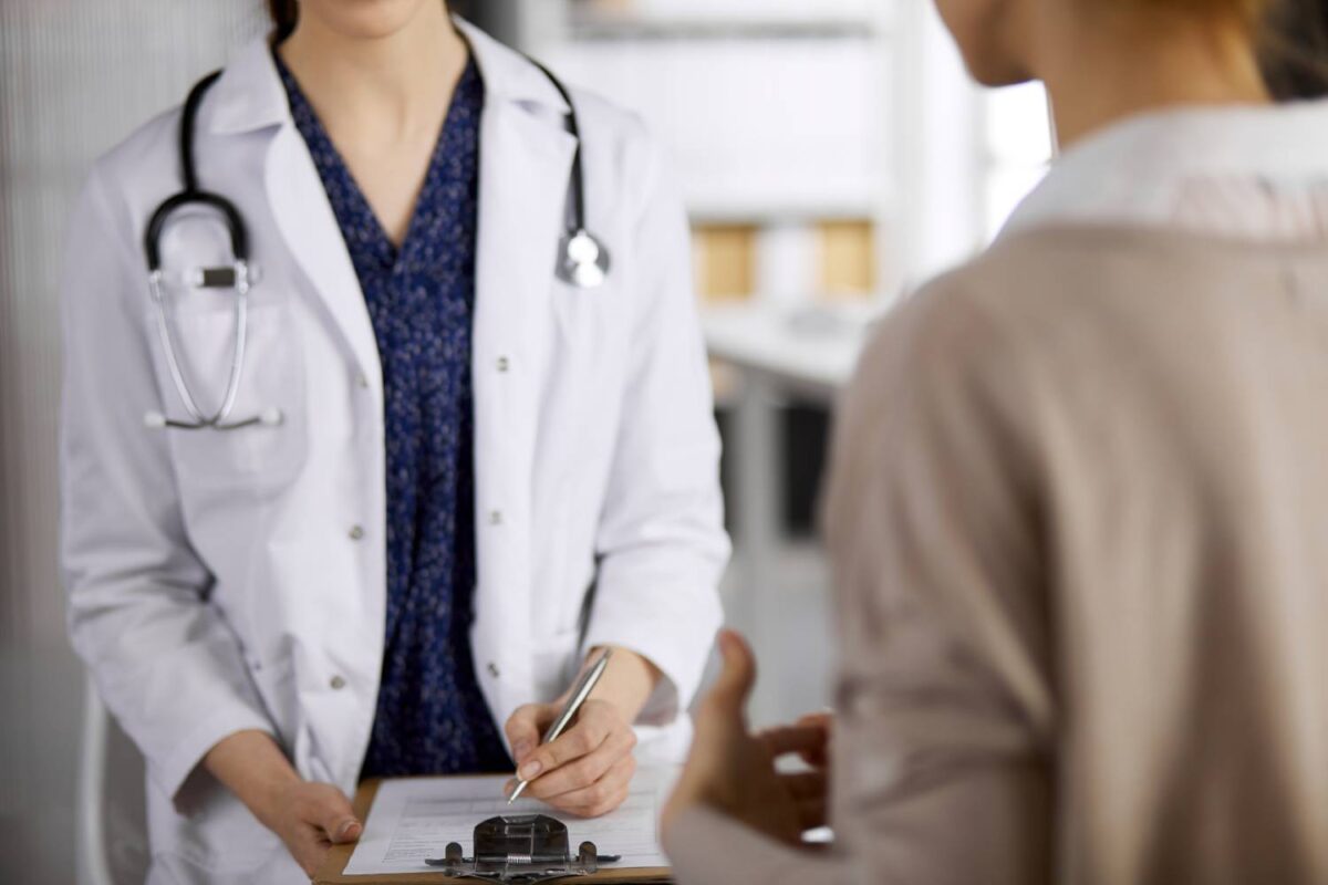 Doctor and patient discussing current health examination while sitting in clinic