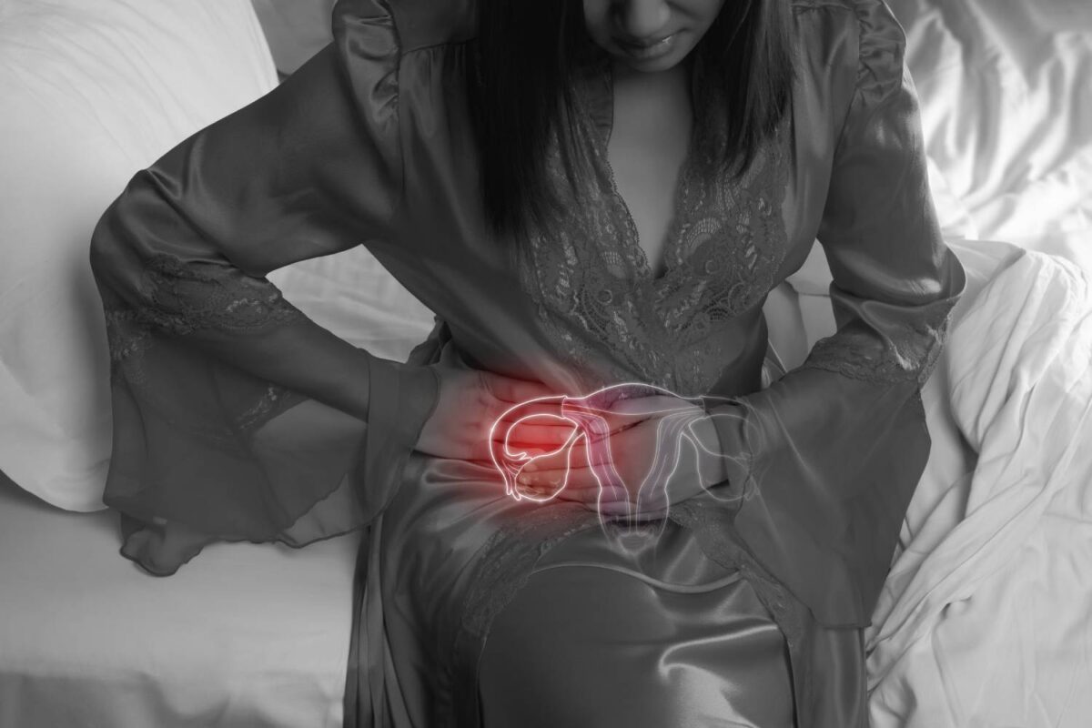 Woman in silk nightgown and lace robe with uterus pain