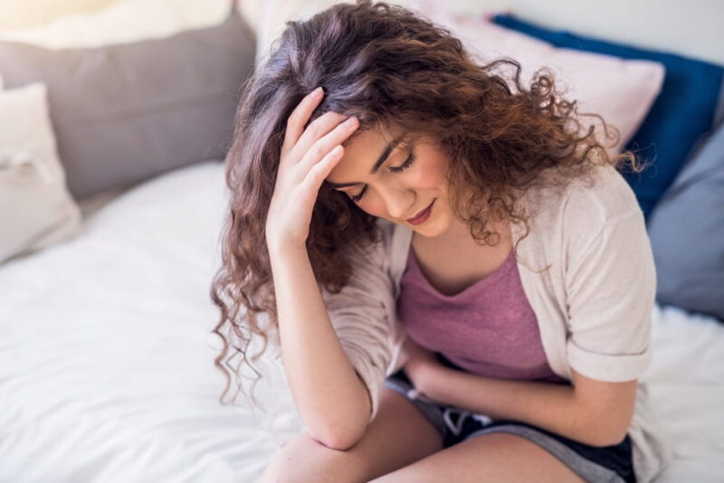 Woman suffering from menstrual pain, having cramps.
